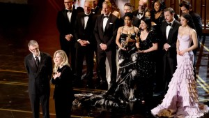 Paul Thomas Anderson, Sarah Murphy, Anthony Carlino, Will Weiske, Andy Jurgensen, Teyana Taylor, Michael Bauman, Cassandra Kulukundis, Regina Hall, Shayna McHale aka Junglepussy, Leonardo DiCaprio, Chase Infiniti and Benicio del Toro accept the Best Picture win for "One Battle After Another" at the 98th Academy Awards. (Kevin Winter/Getty Images)