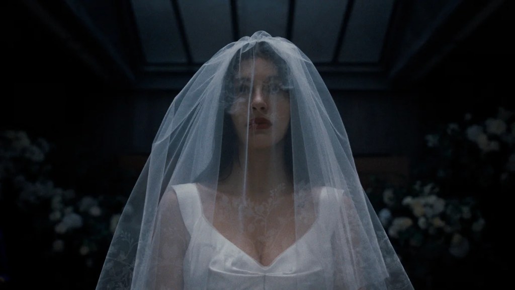 Camila Morrone wears a wedding dress in "Something Very Bad Is Going to Happen" (Netflix)